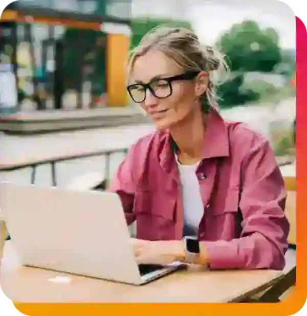 image of a lady at a table on a laptop