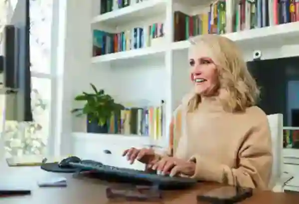A cheerful lady working on a computer at her workstation