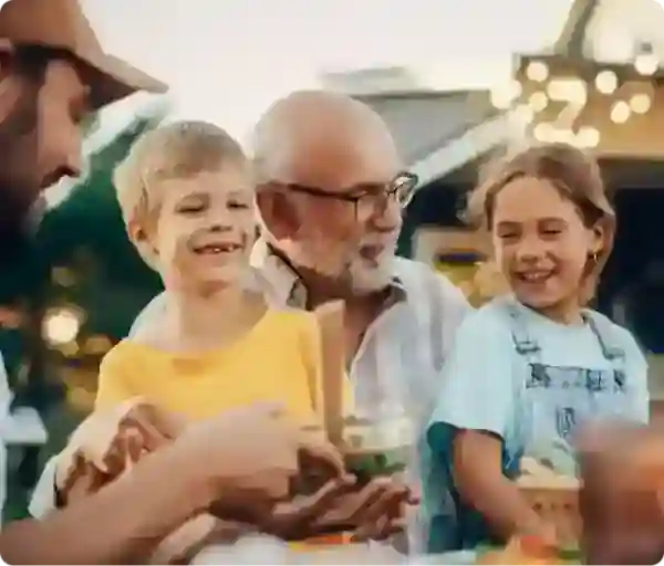 grandpa with glasses holding grandchildren